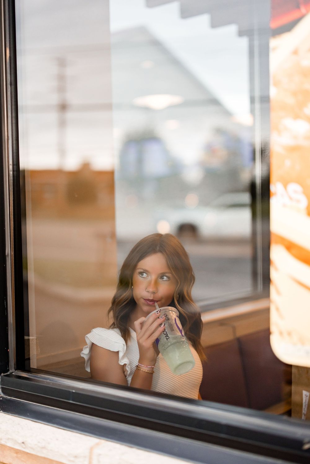 Series of photos through a restaurant window showing someone enjoying a meal inside.