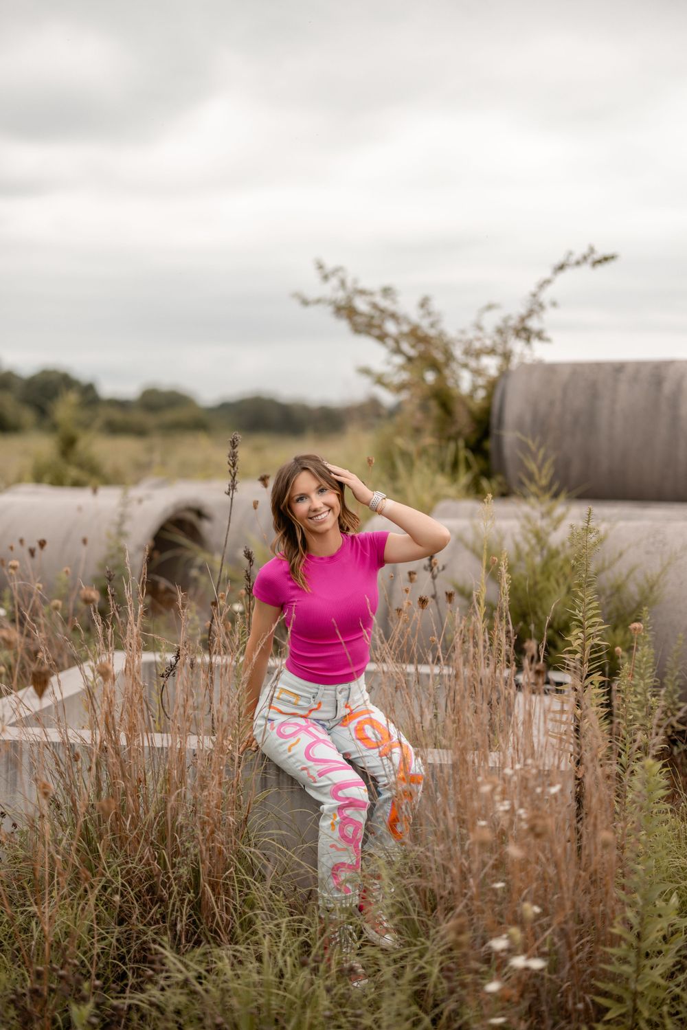Dance-like movements against a natural backdrop of tall grasses and wildflowers in an outdoor field setting.