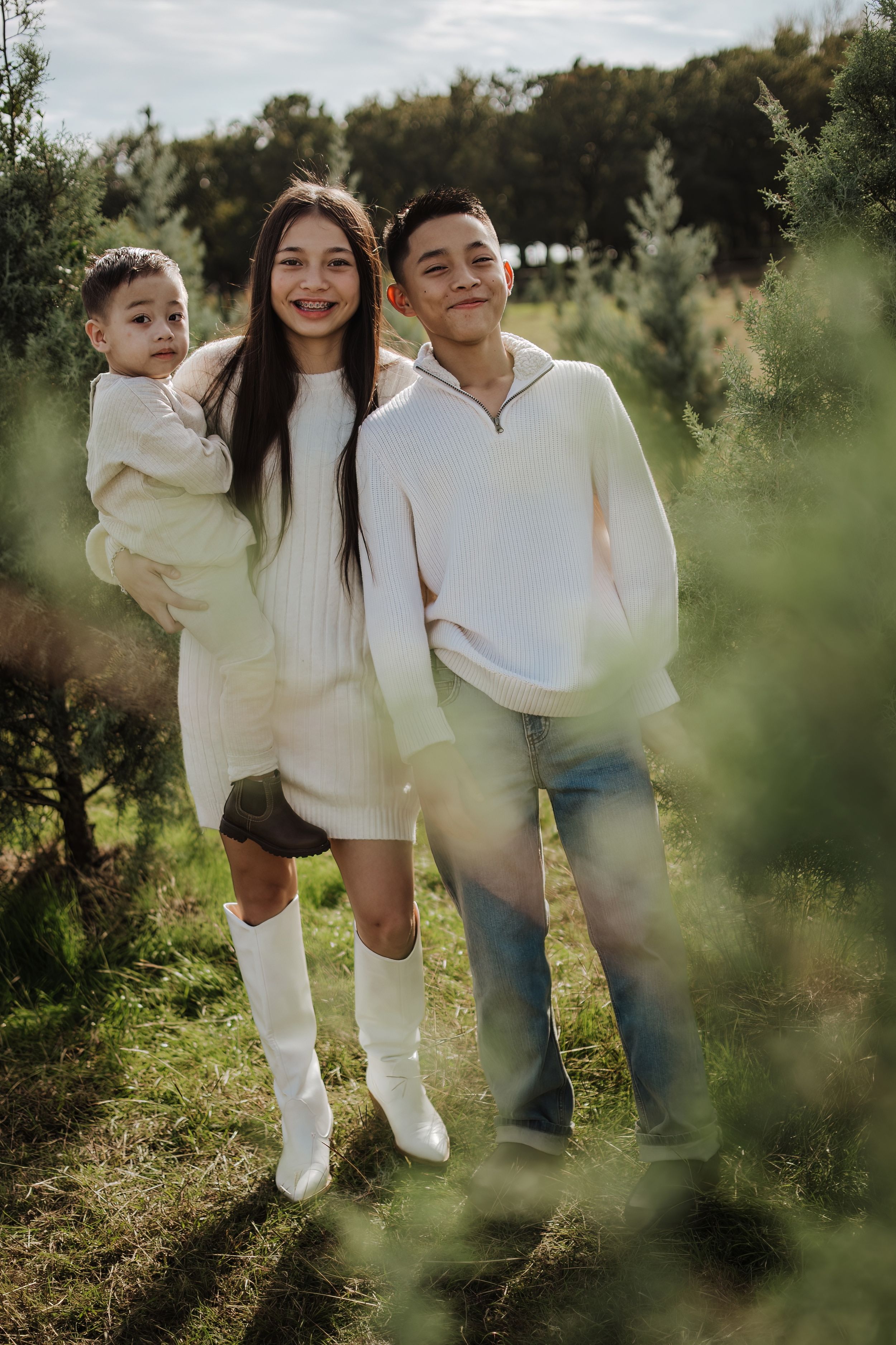 Dfw Tree Farm Casual family photos taken in a sunlit outdoor setting with natural foliage.