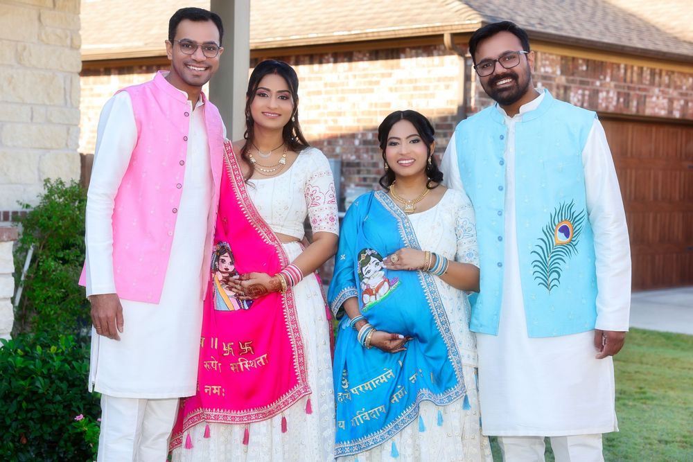 Group wearing colorful traditional Indian outfits poses together at outdoor gathering.