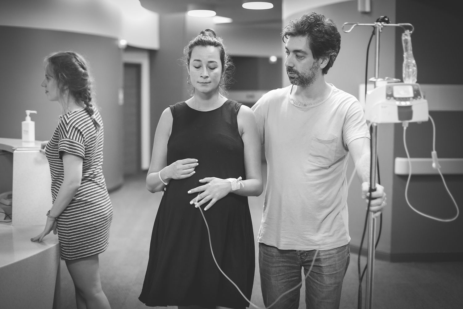 Physical therapists help patient perform rehabilitation exercises in a medical clinic setting.