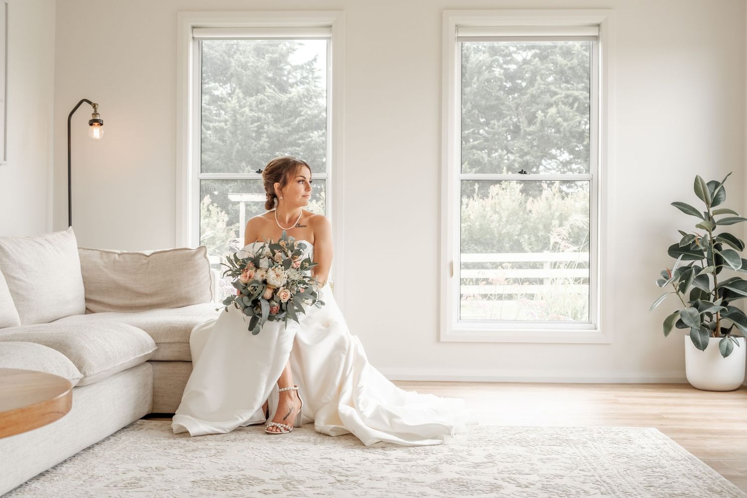 Bright and airy bridal portraits taken in a modern white room with large windows.