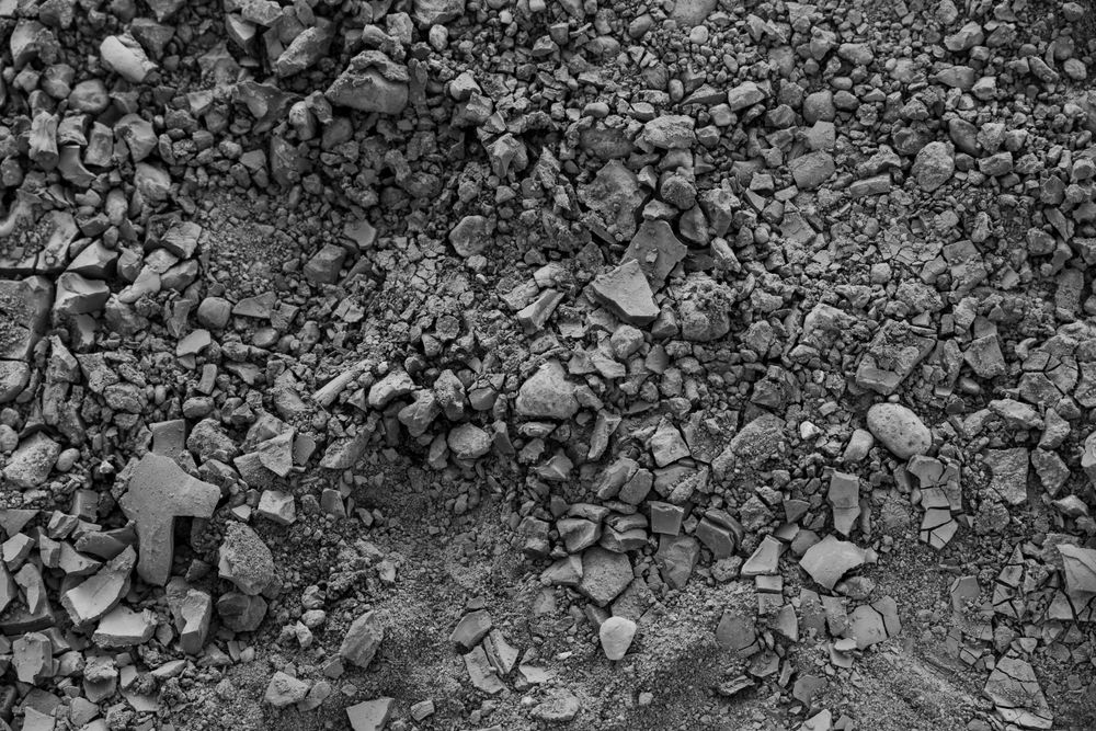 Close-up texture of rocky ground with scattered pebbles and stones.