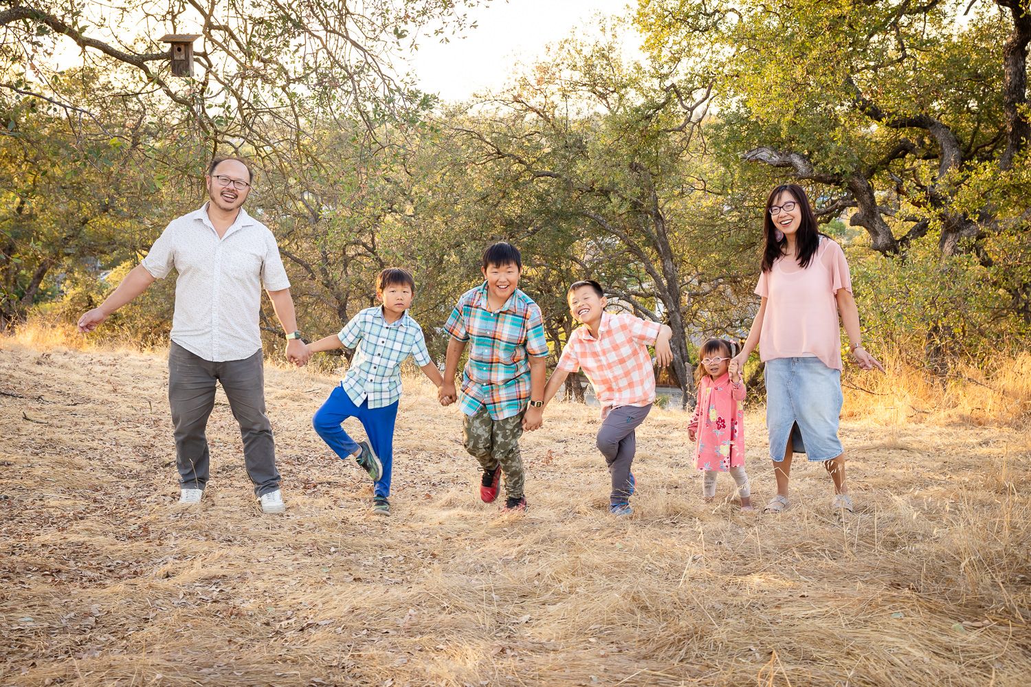 Family has fun dancing during family photoshoot with Bay Area Photographer Cindy Tucey in San Jose