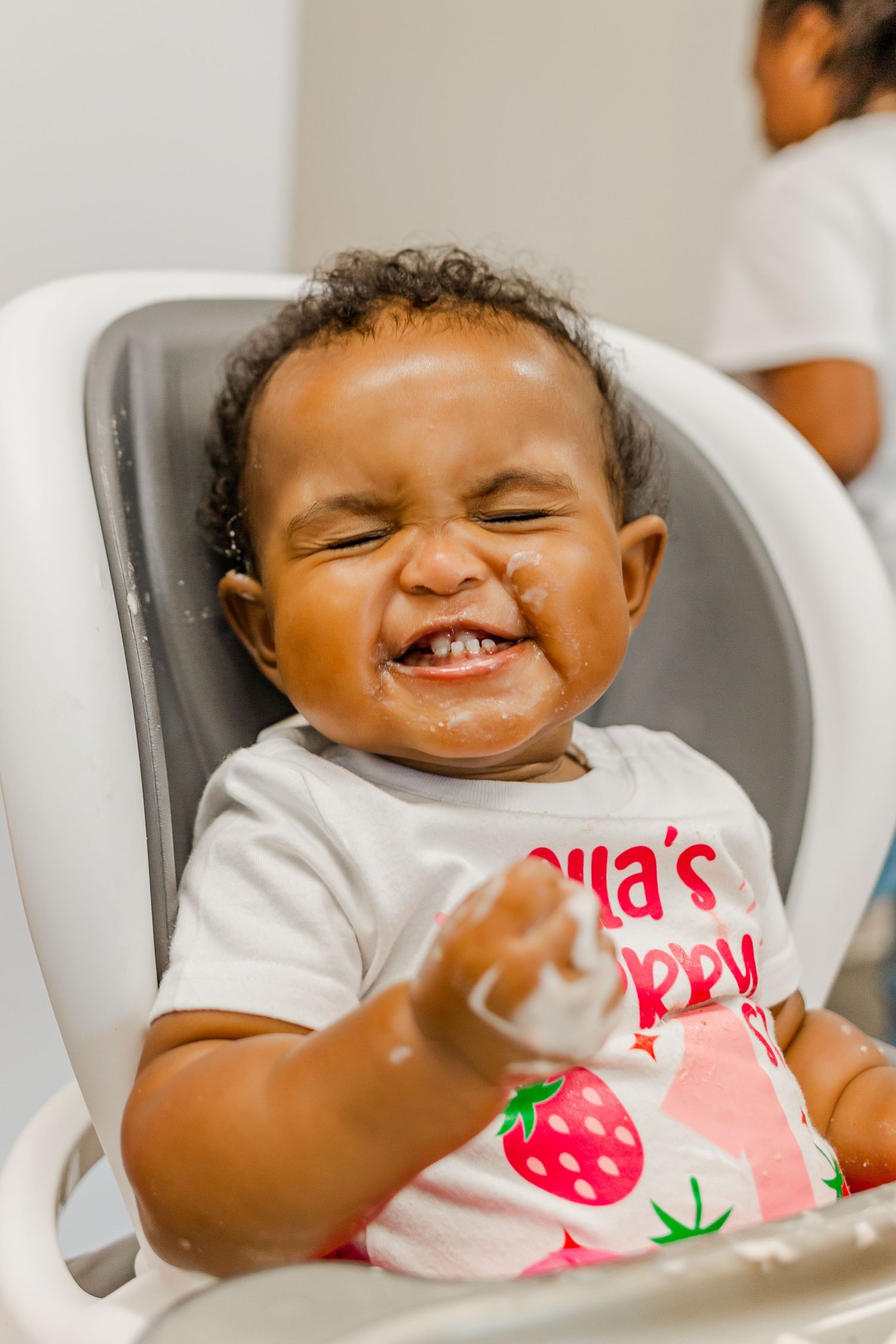 A joyful laughing expression captured during a birthday celebration.