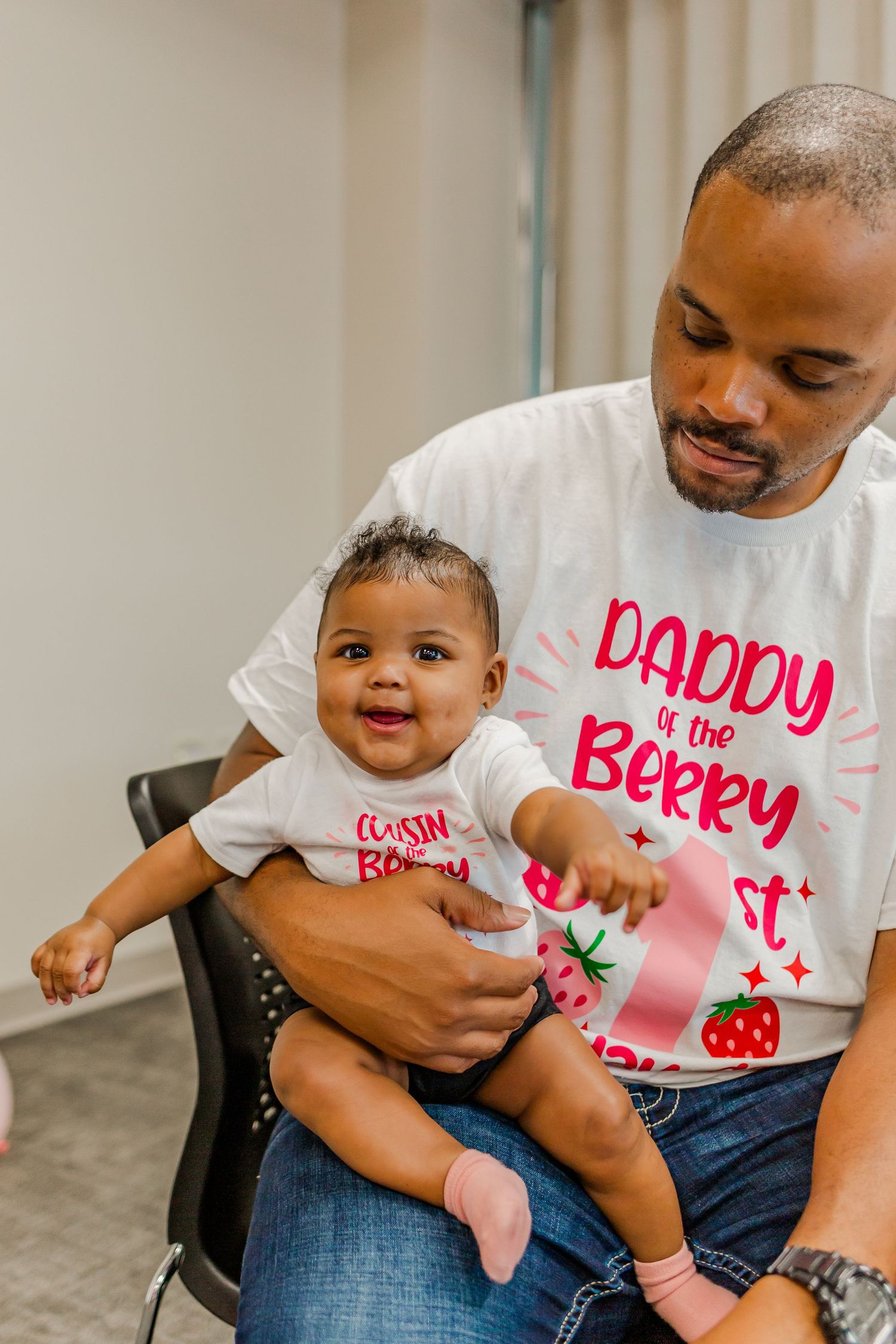 A sweet family moment with matching berry-themed t-shirts during a celebration.