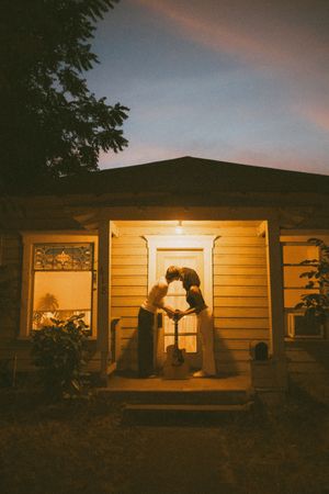 A sequence of panoramic shots showing a house exterior with warm window lighting at dusk.