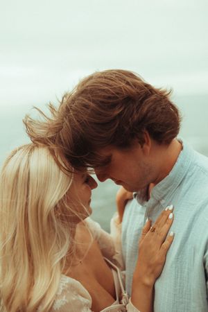 A romantic sequence of photos showing a couple in intimate poses against a soft, dreamy background.