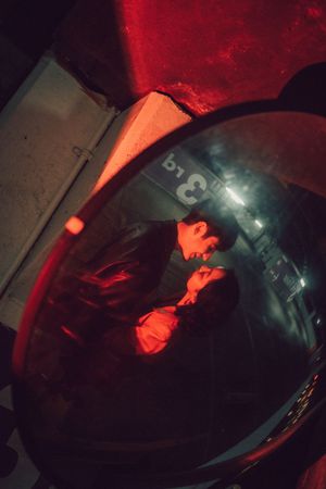 Close-up shots of a vinyl record spinning on a turntable under dramatic red lighting.