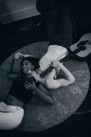 A dramatic black and white photo sequence showing a figure lying on a dark textured surface.
