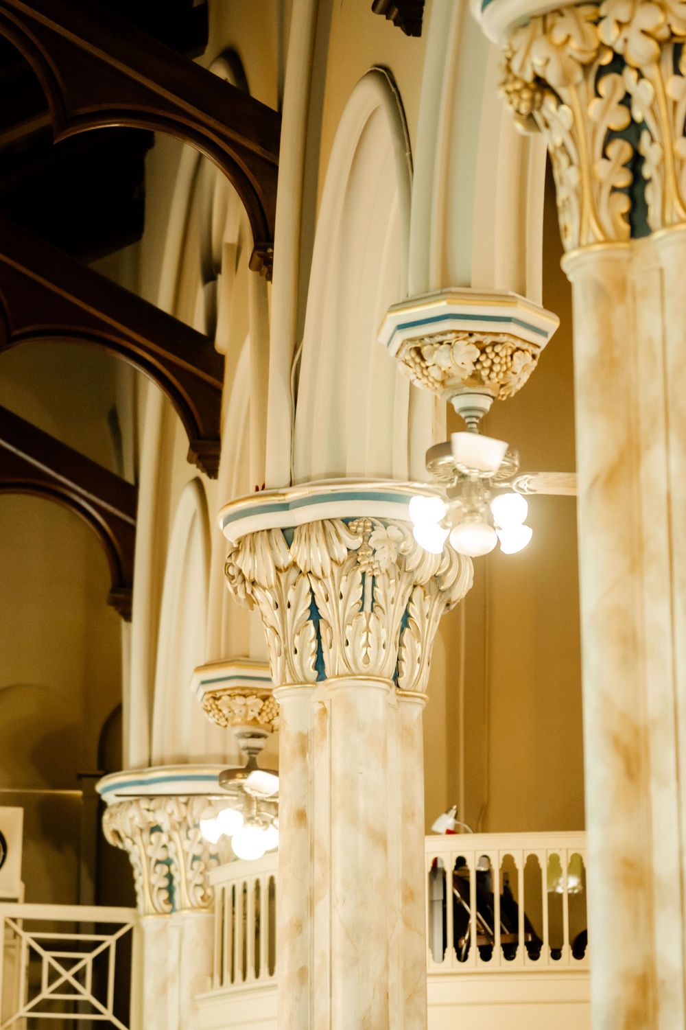 Elegant church interior with ornate columns and decorative capitals featuring classical architectural details.