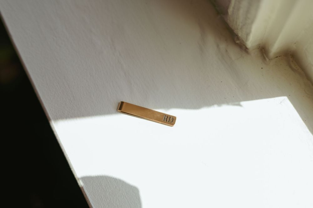 A white paper boat photographed in sequence as it moves across seven frames on a light background.