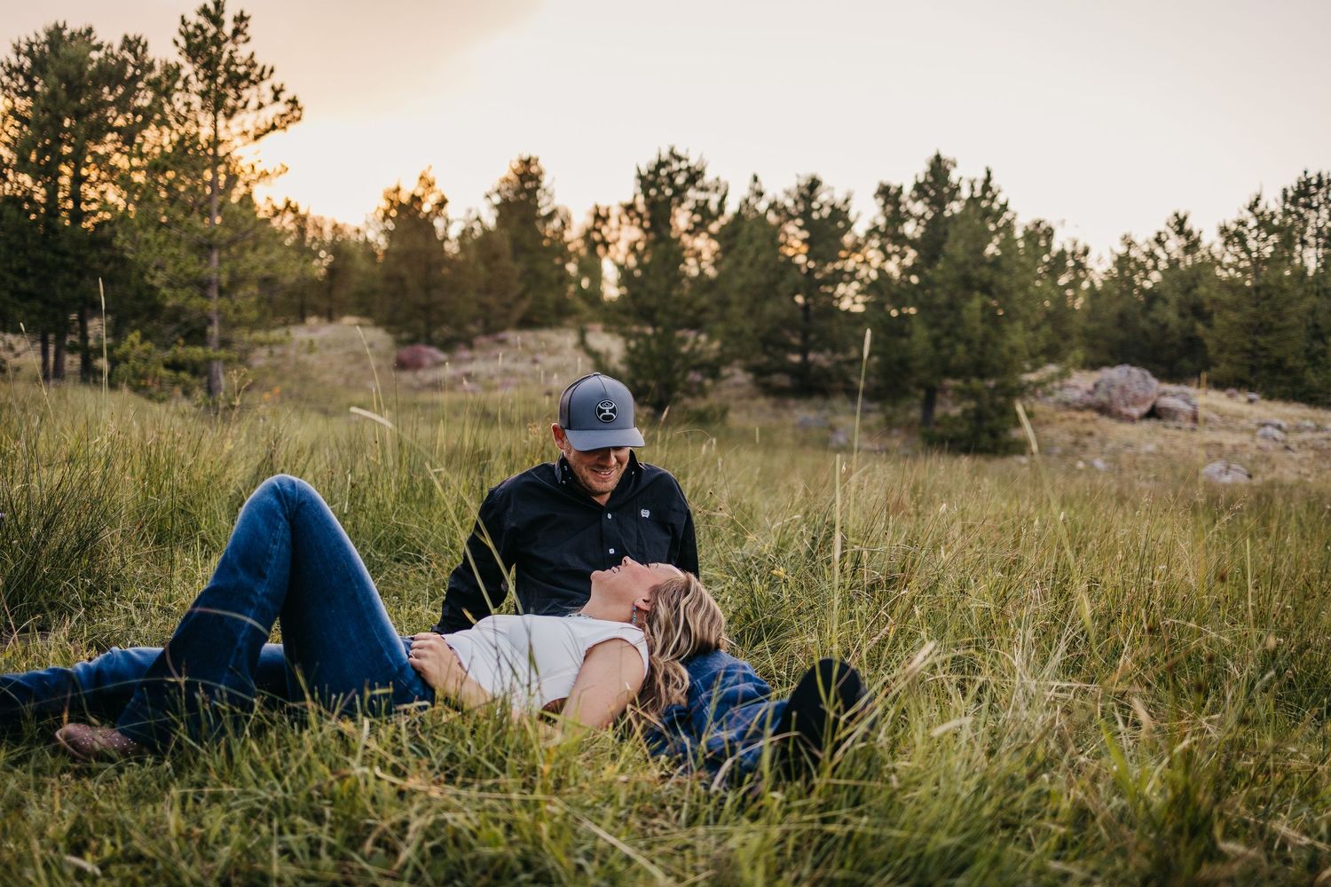 Creative portrait session on the mountain in dreamy lighting using beautiful flowers and a boho lace backdrop.