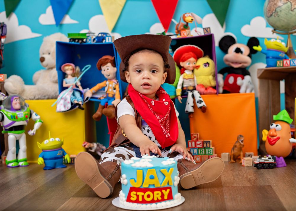 Colorful Toy Story themed children's party decorations and toys arranged in a festive display on a wooden table.