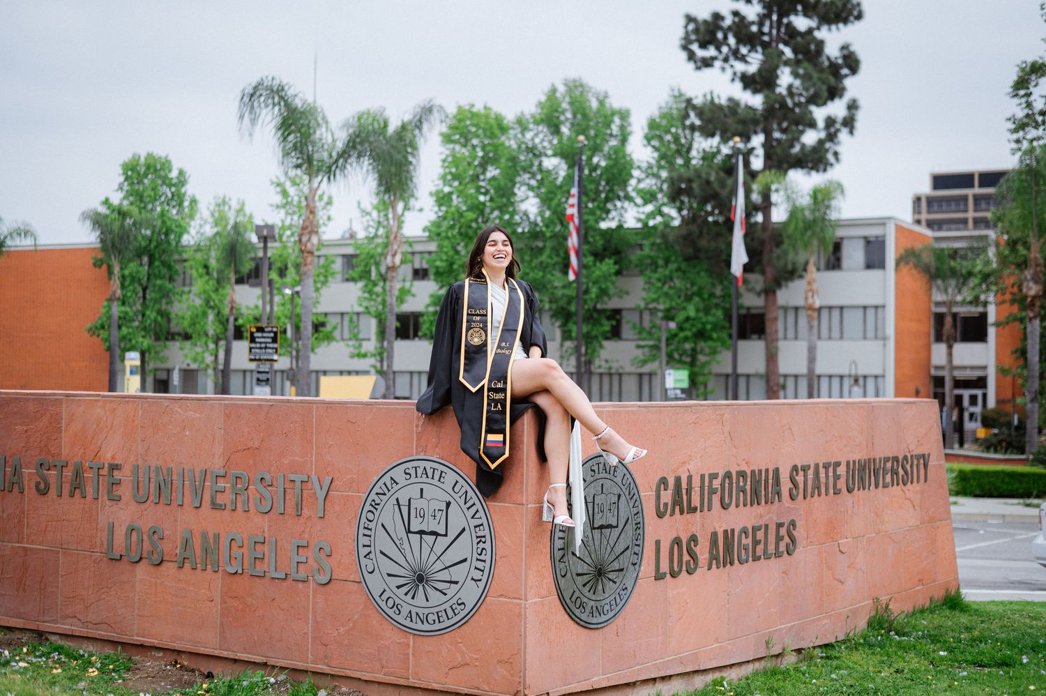 Orange university wall with California State University Los Angeles logo and text stretches across campus.