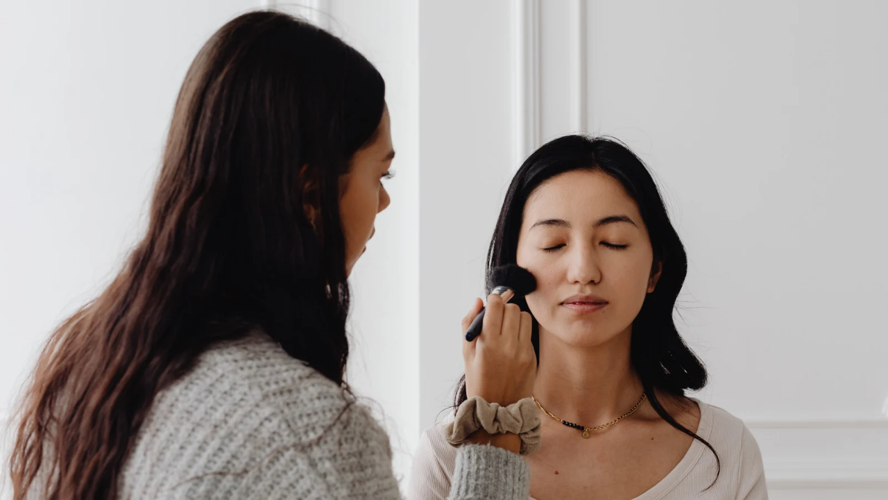Grooming and final touches for a photoshoot - A white make up artist in the UK and her client