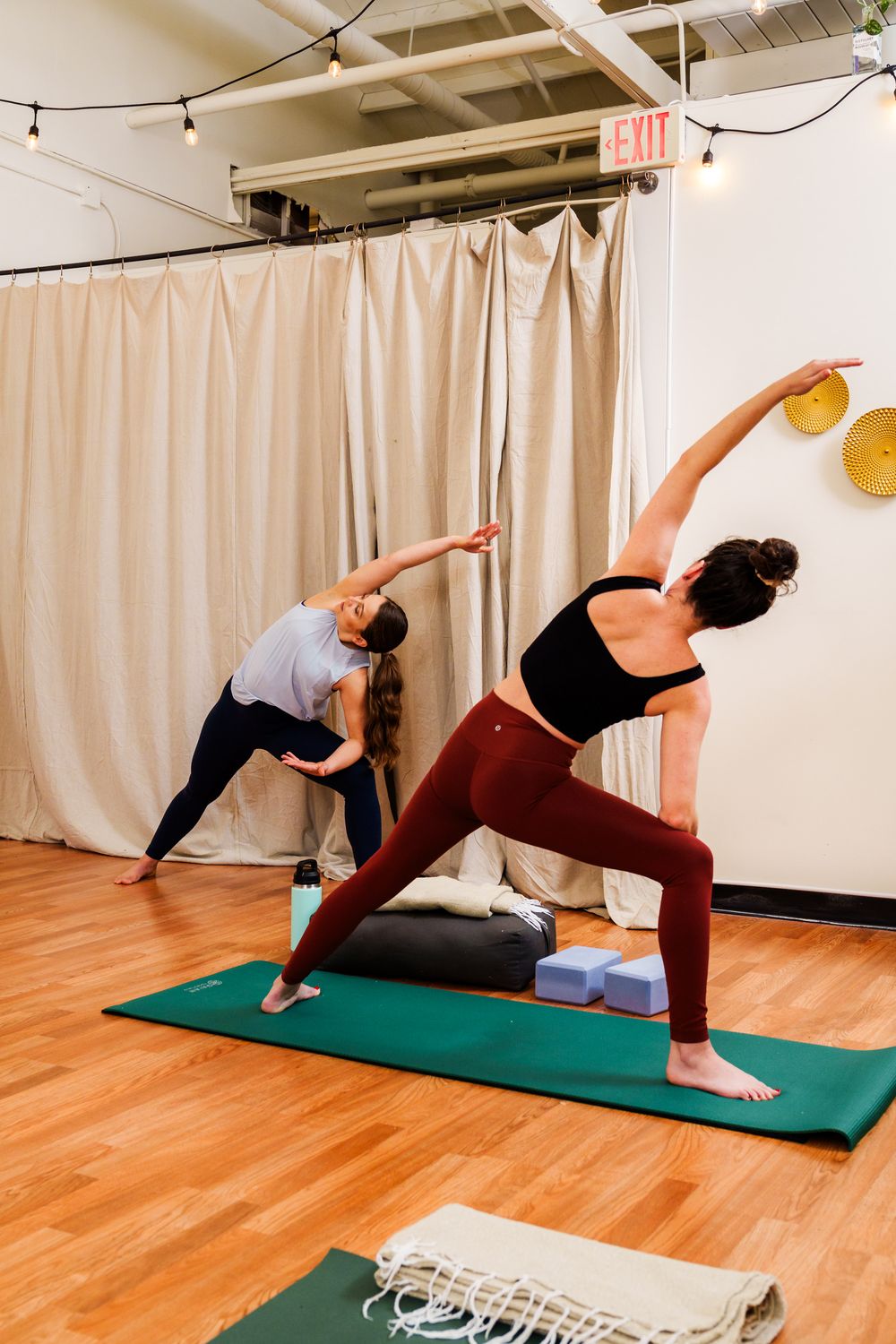 Series of yoga poses showing fluid movement through side plank variations on a green exercise mat.