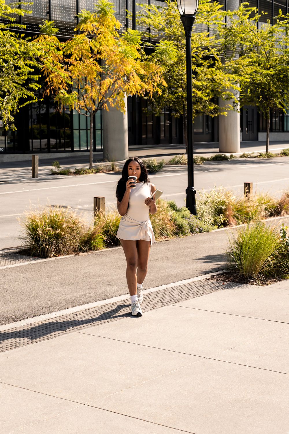 A sequence of photos showing someone walking along a sidewalk with bright yellow autumn trees and lamp posts.
