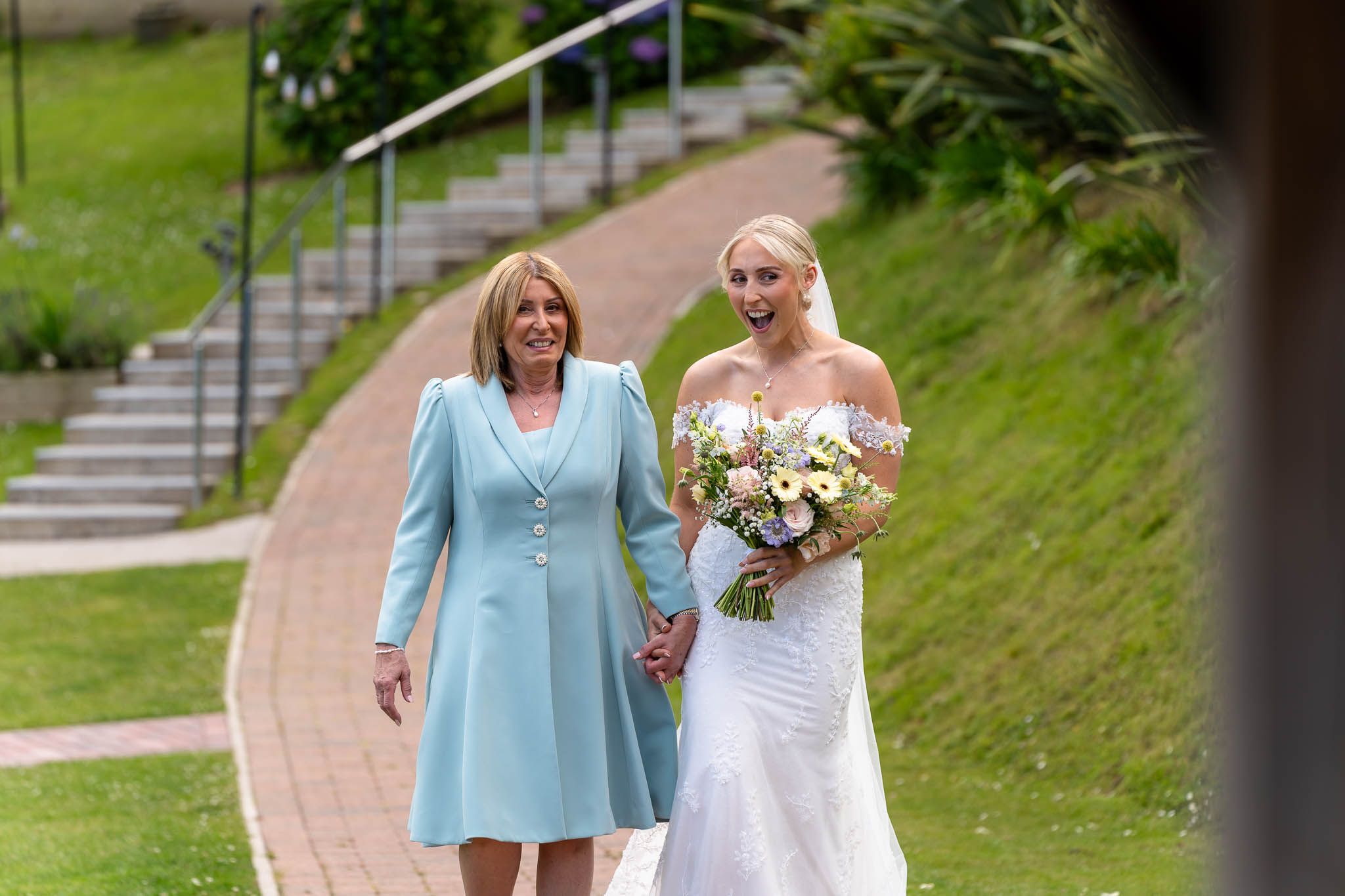 Bride and Mother walking to ceremony at Sandy Cove Hotel