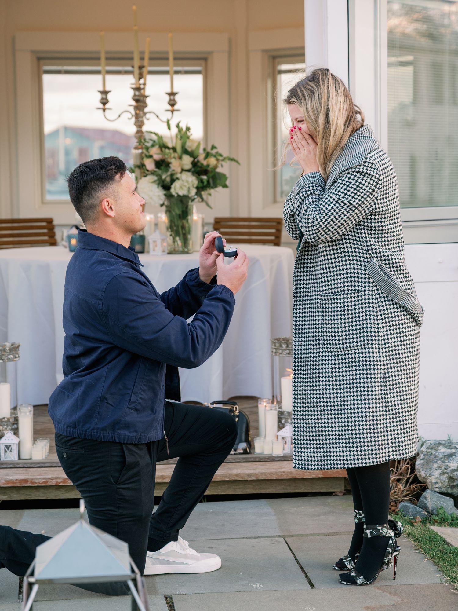 A series of photos showing a surprise proposal moment at home with a couple in navy and houndstooth outfits.