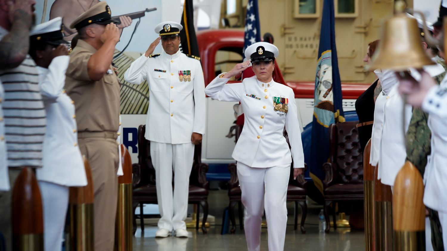 Military personnel in white uniforms gather for a formal ceremony or event.