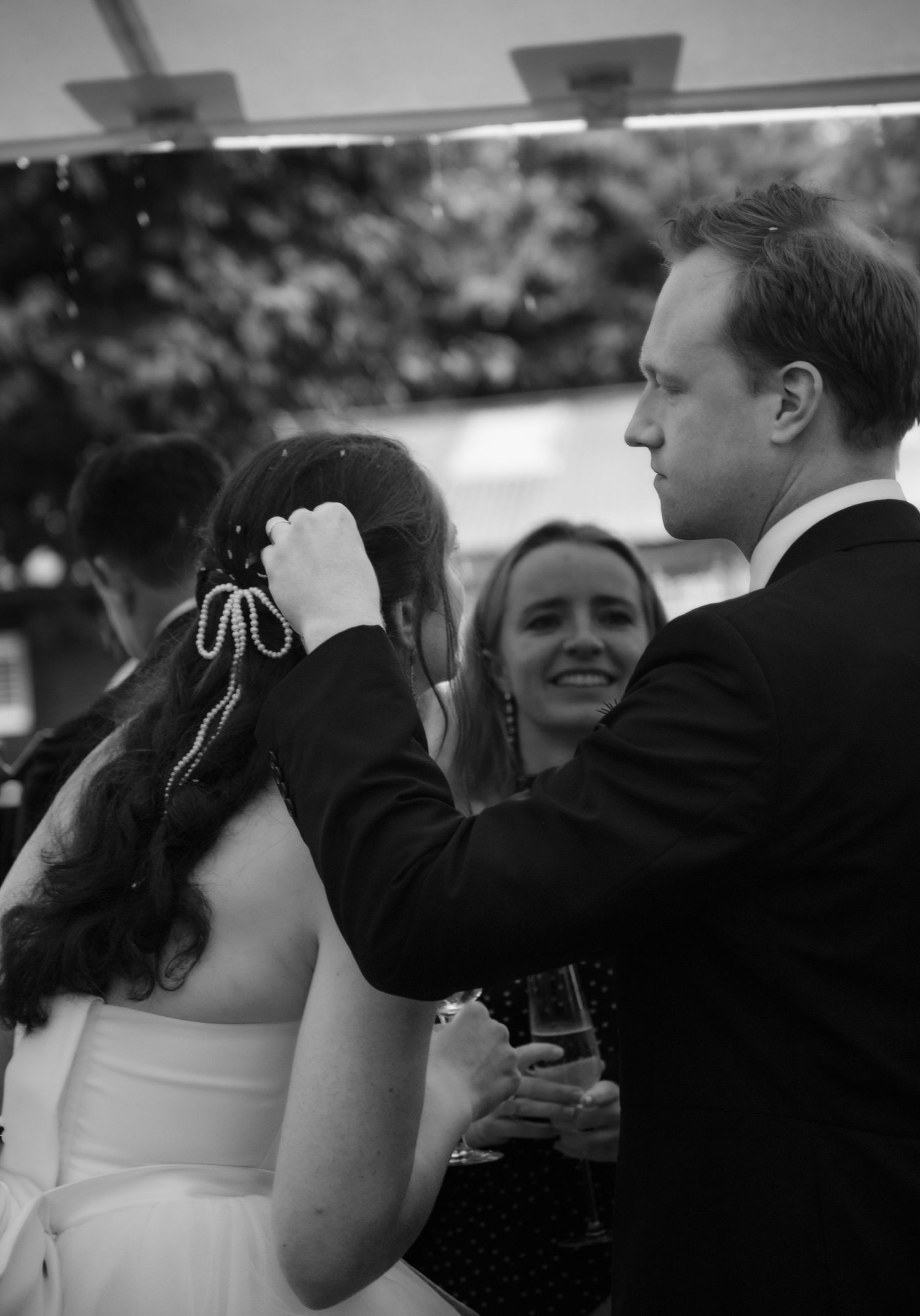 confetti in hair bride and groom black and white documentary wedding photography