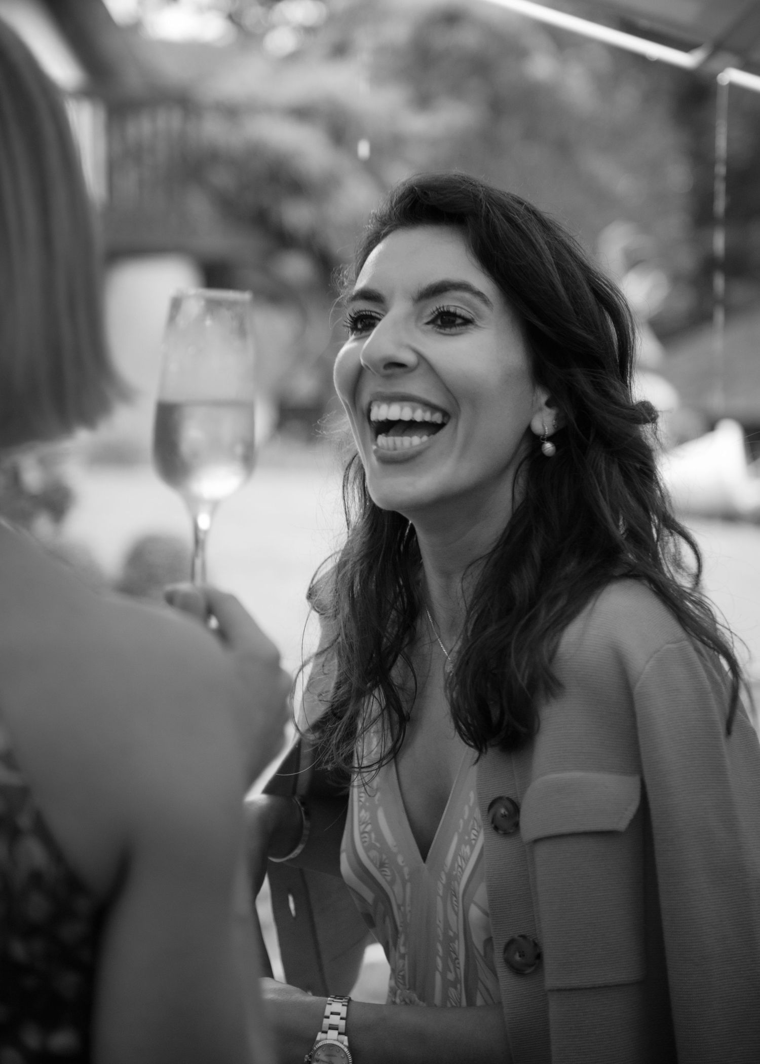 wedding guest mingling laughing black and white candid photography editorial