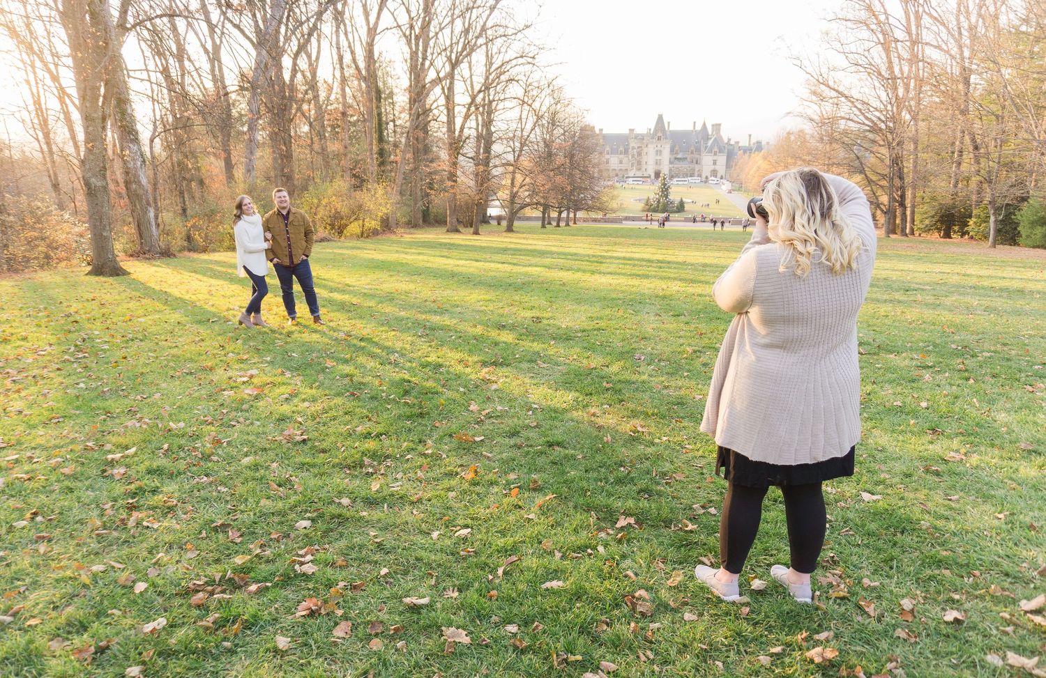 Autumn outdoor photo session with fallen leaves and golden sunlight.