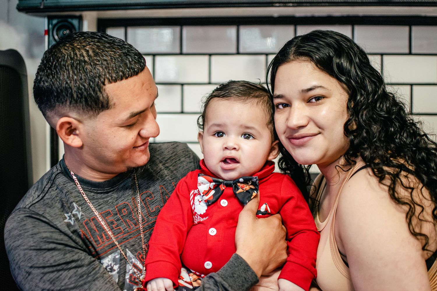 Parents holding their baby during a Christmas family photo session in Puyallup, Washington