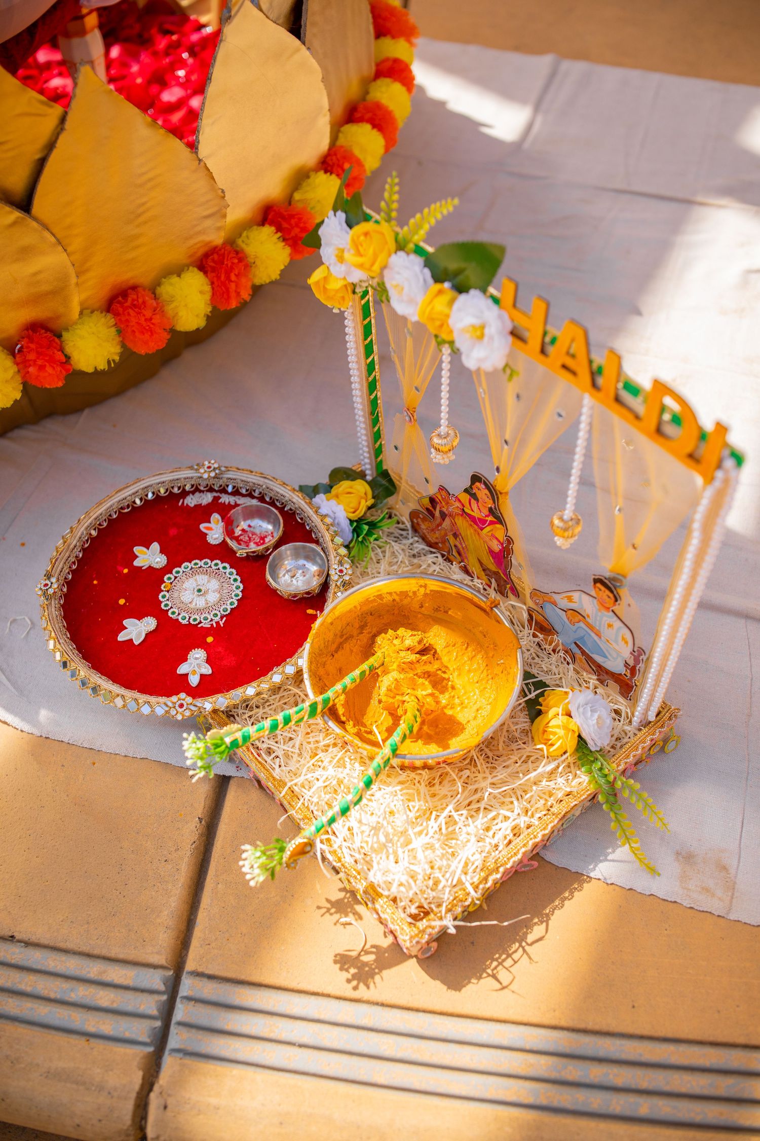 Colorful decorative ornaments with red and gold details hang from above.