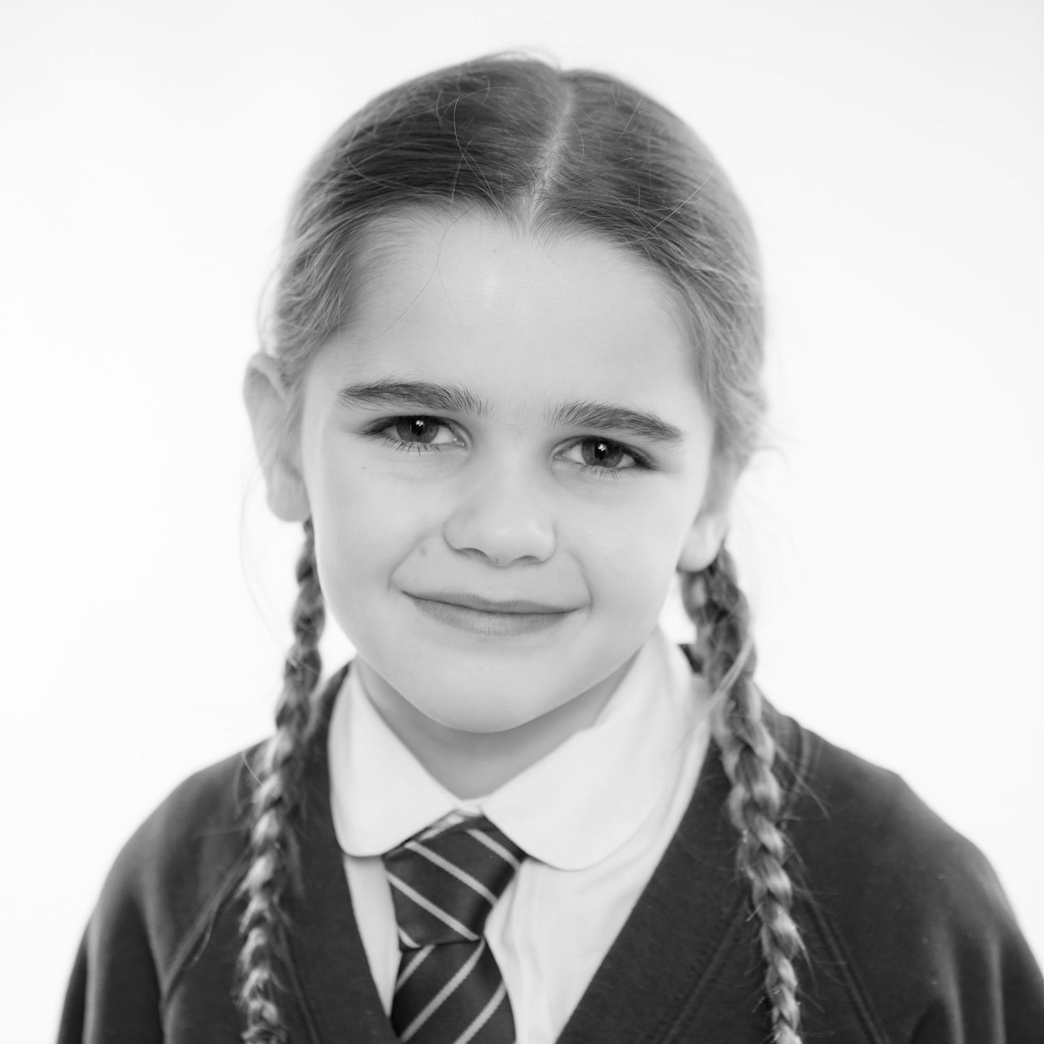 Photo of a young girl showing an option in black and white. A school studio photo taken on a white background.