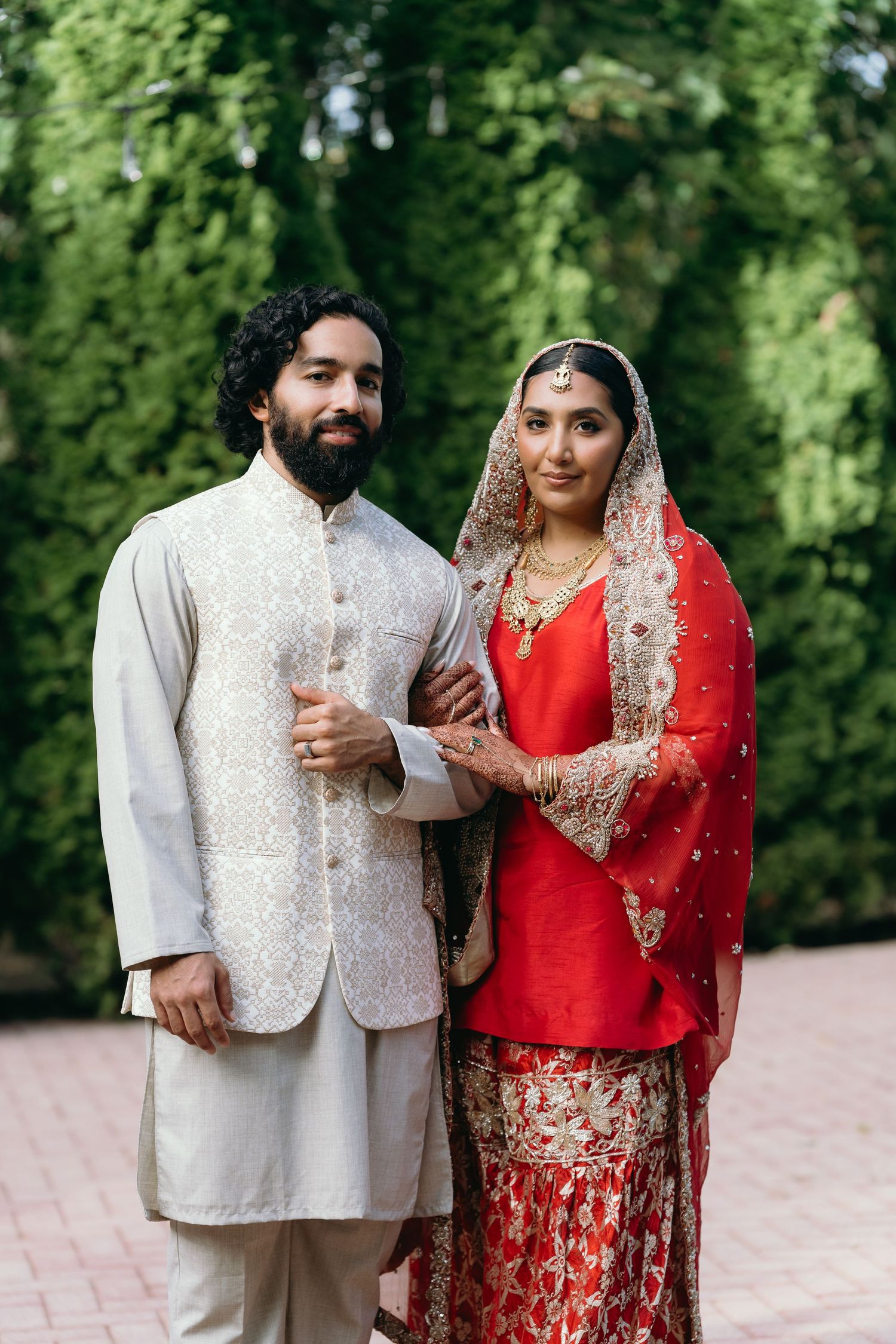 Elegant brownstone entrance with wooden doors and stone steps creates a classic backdrop for a wedding photo session.