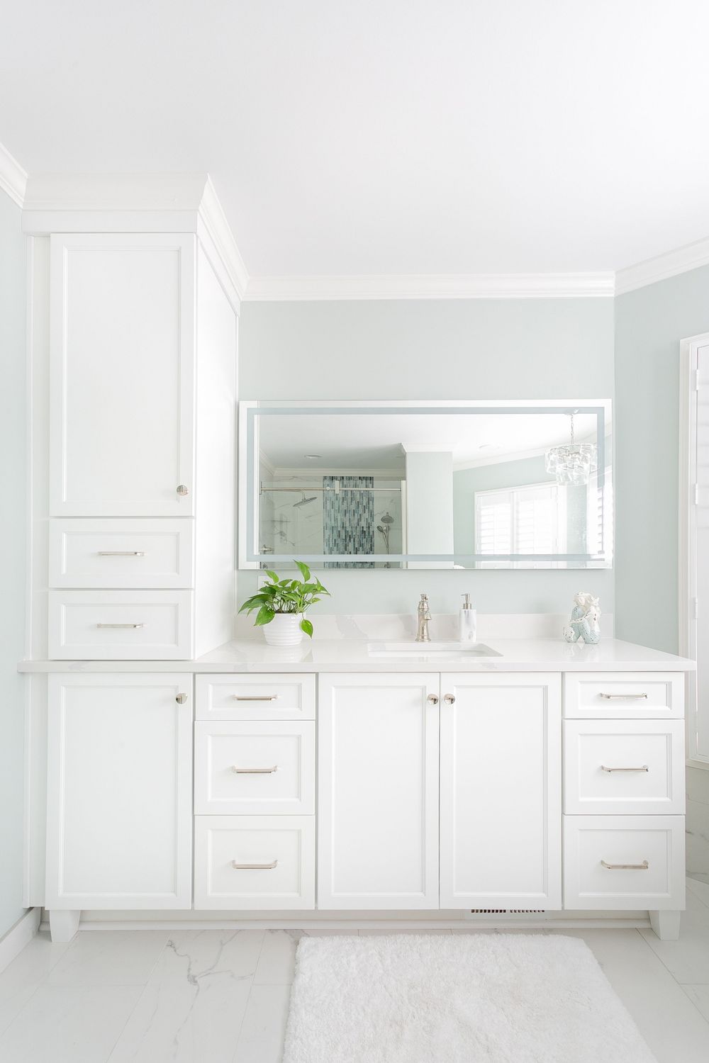 Clean modern bathroom featuring white cabinetry and mirrors in a minimalist design.