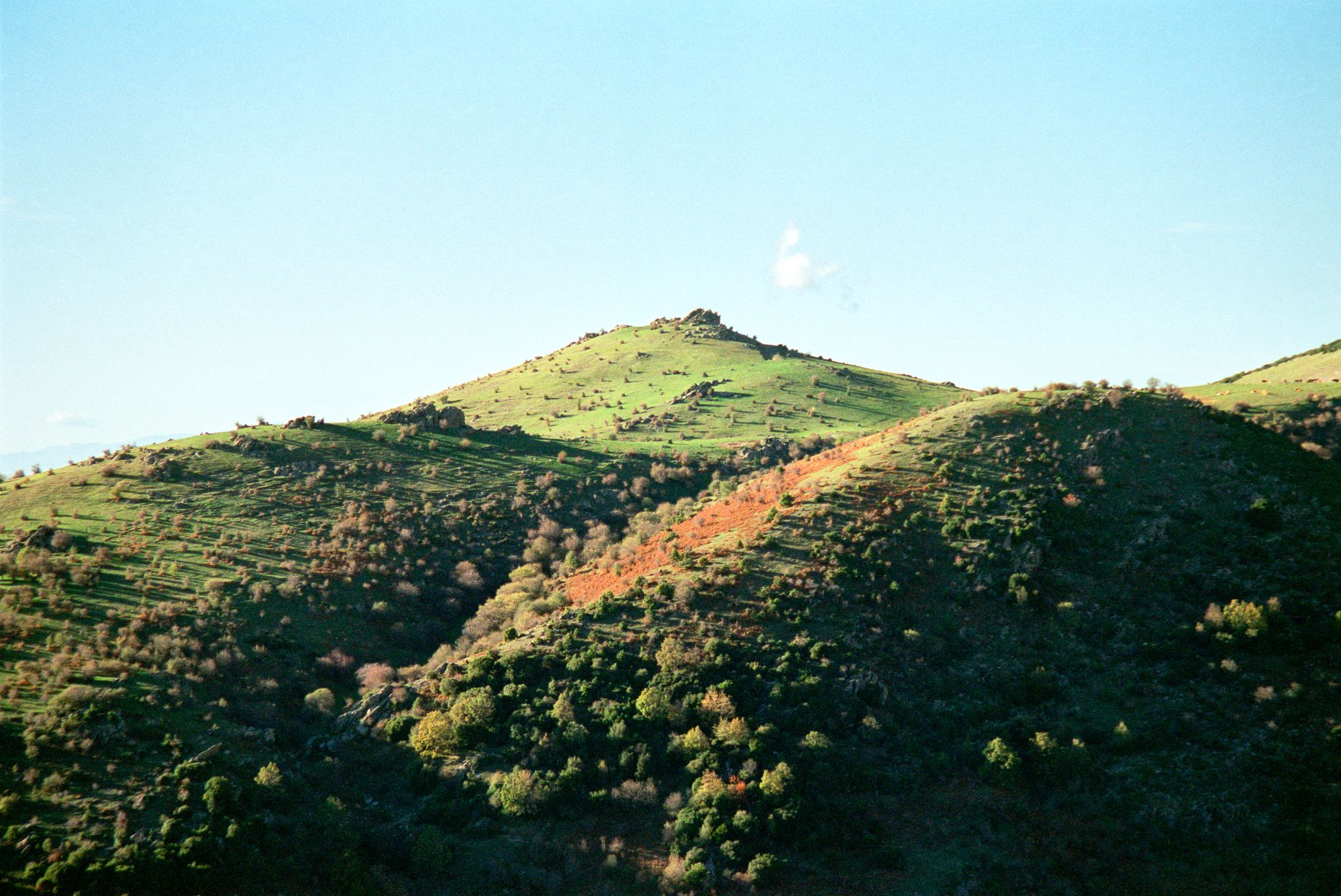 Mountain landscape with green hills and natural terrain in countryside environment.