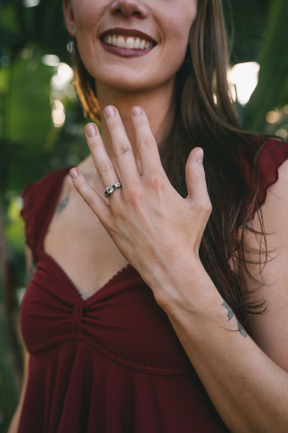 Close-up shots of hands showing off a ring with natural lighting and greenery in background.