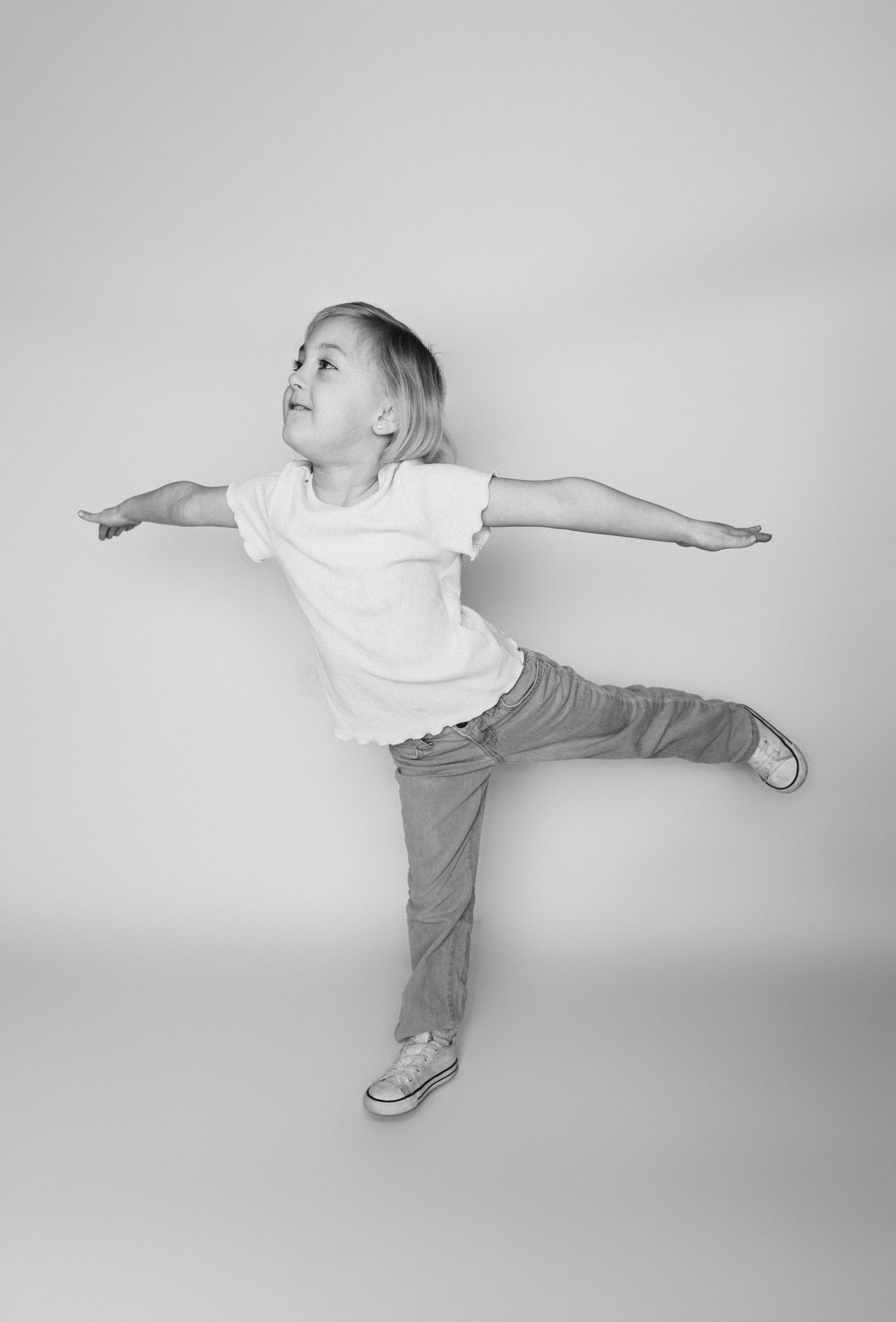 Child sitting in front of a clean white backdrop during an at-home personality portrait session in Marlton, NJ.