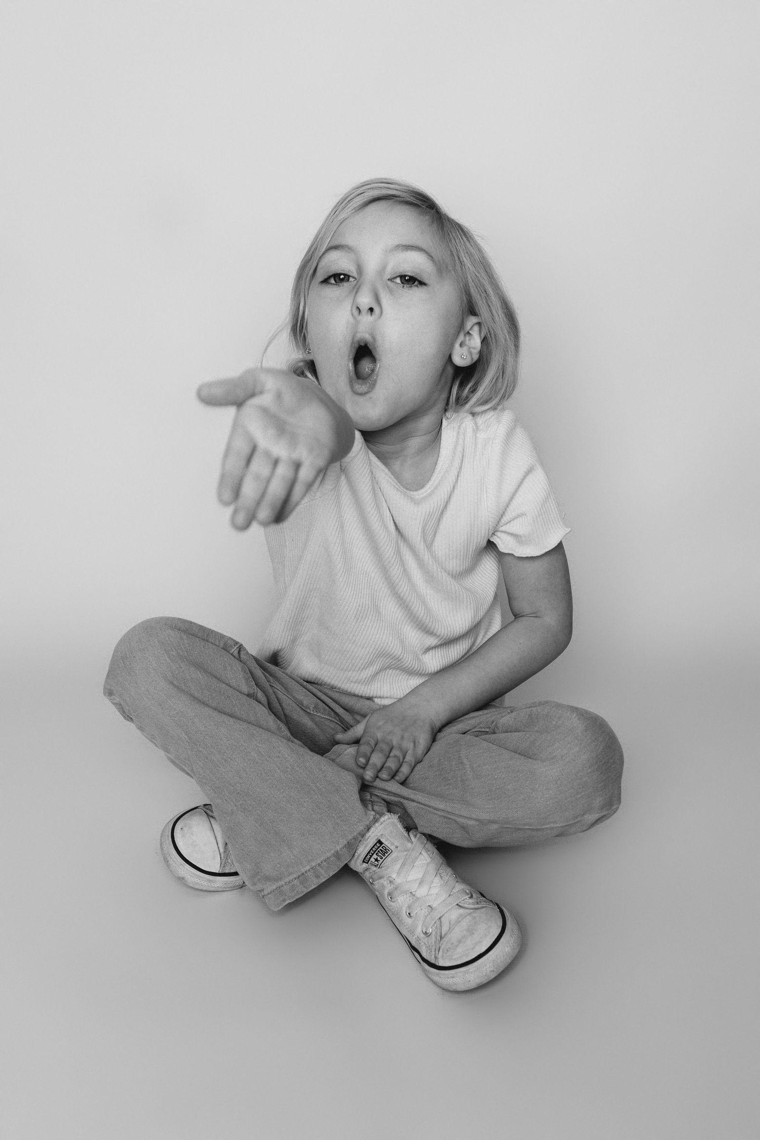 Child sitting in front of a clean white backdrop during an at-home personality portrait session in Marlton, NJ.