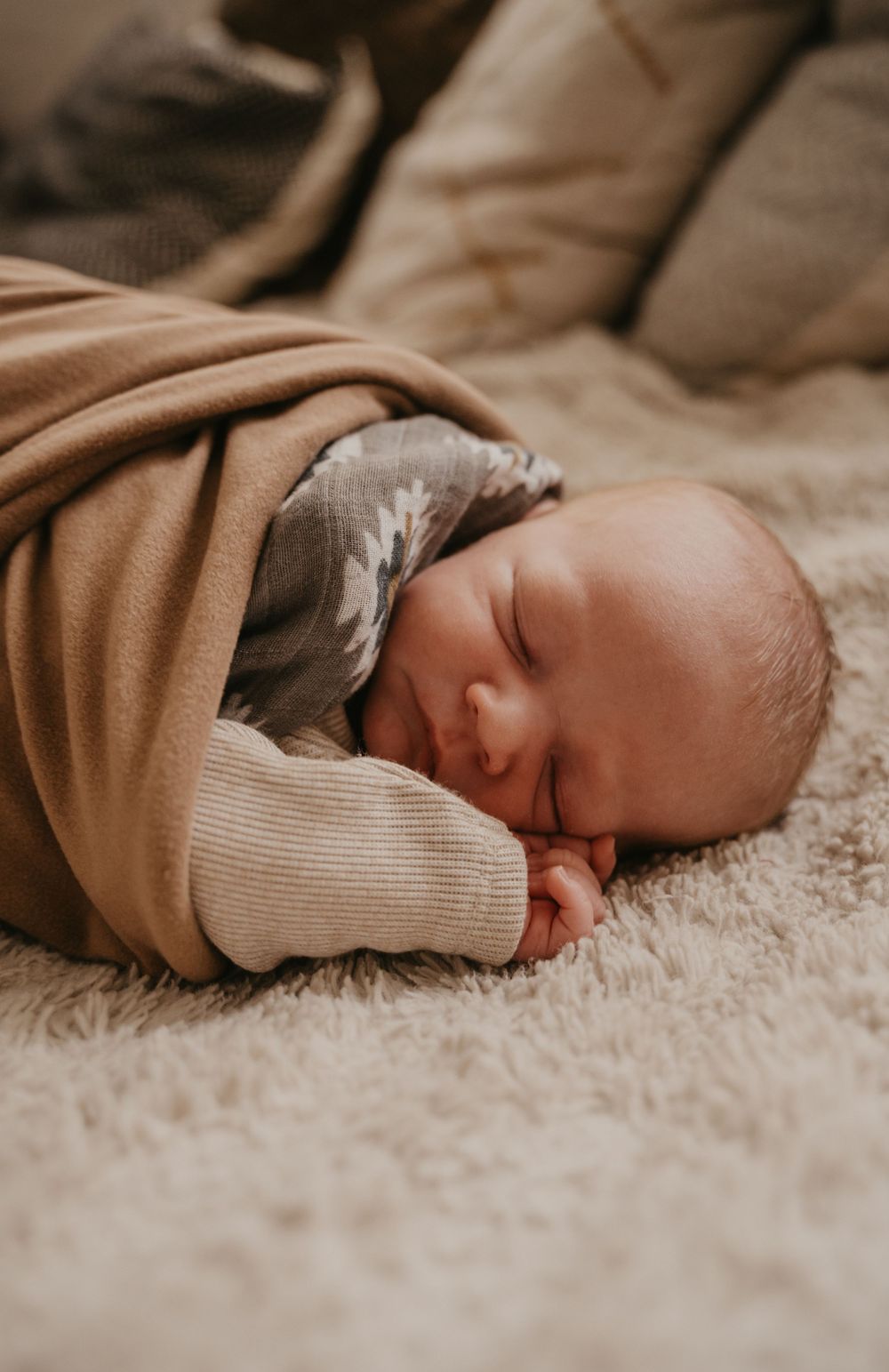 Peaceful sleeping baby in soft brown clothing lying on plush carpet in a sequence of photos.