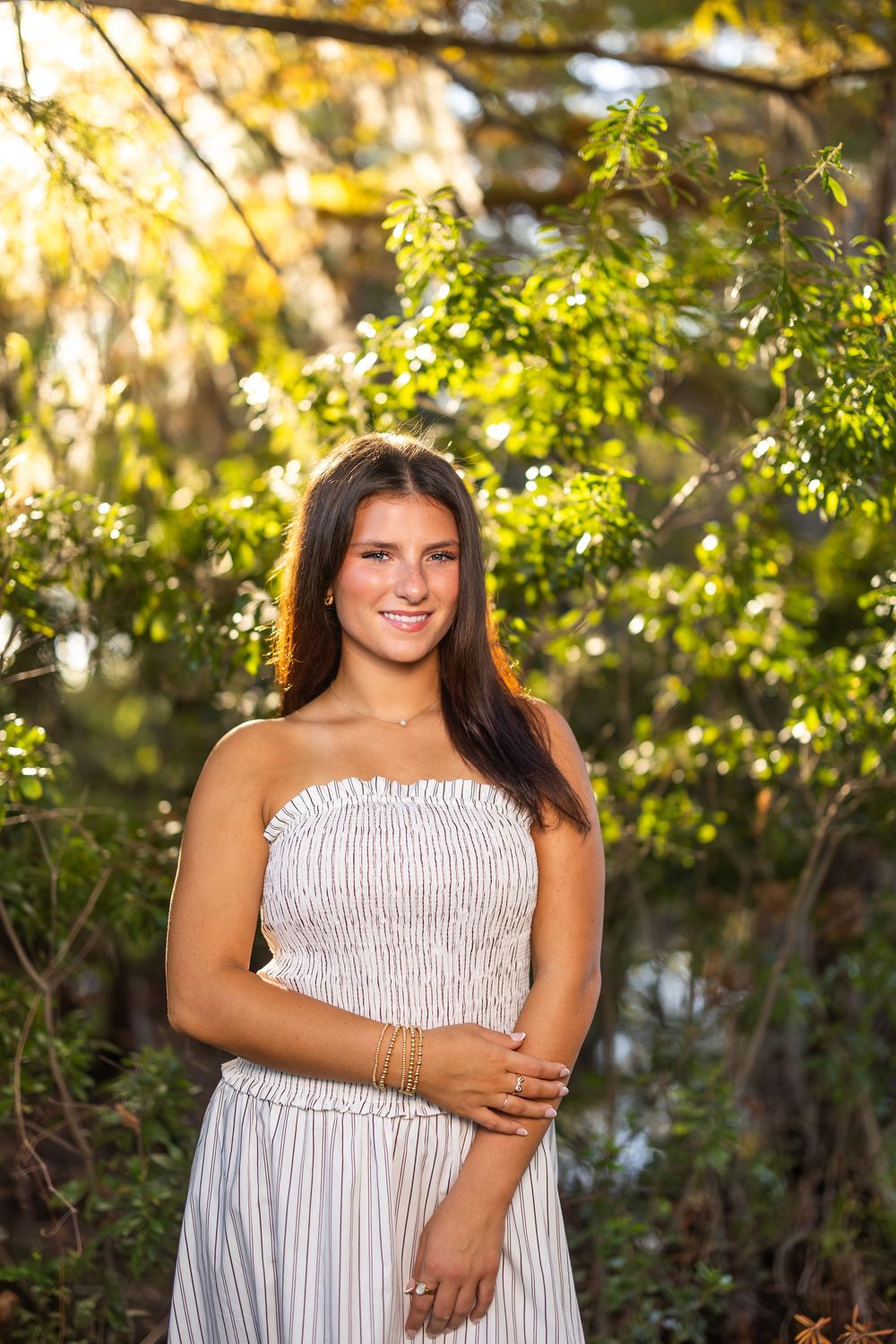 Summer portrait session featuring a white striped sundress in natural outdoor lighting.