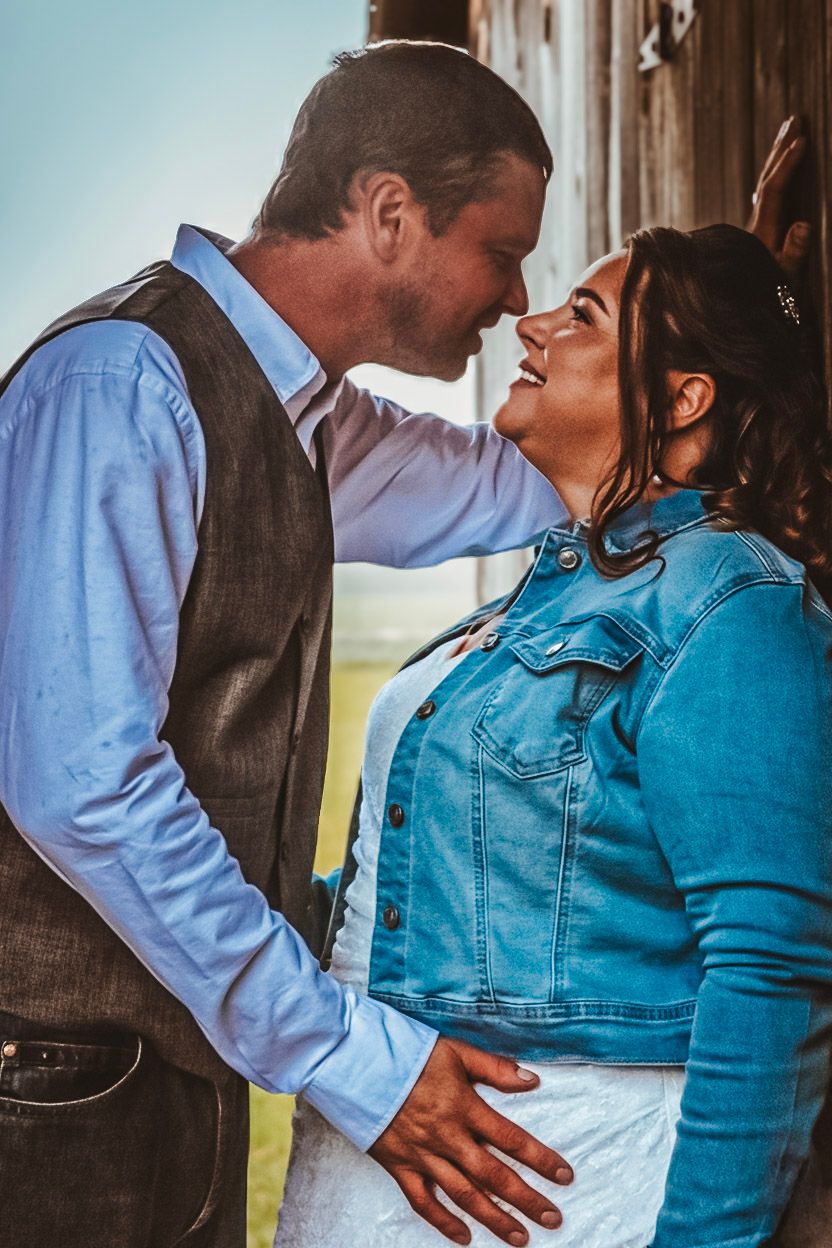 Wedding portrait by Northern Exposure featuring a bride and groom leaning in for a kiss with each other