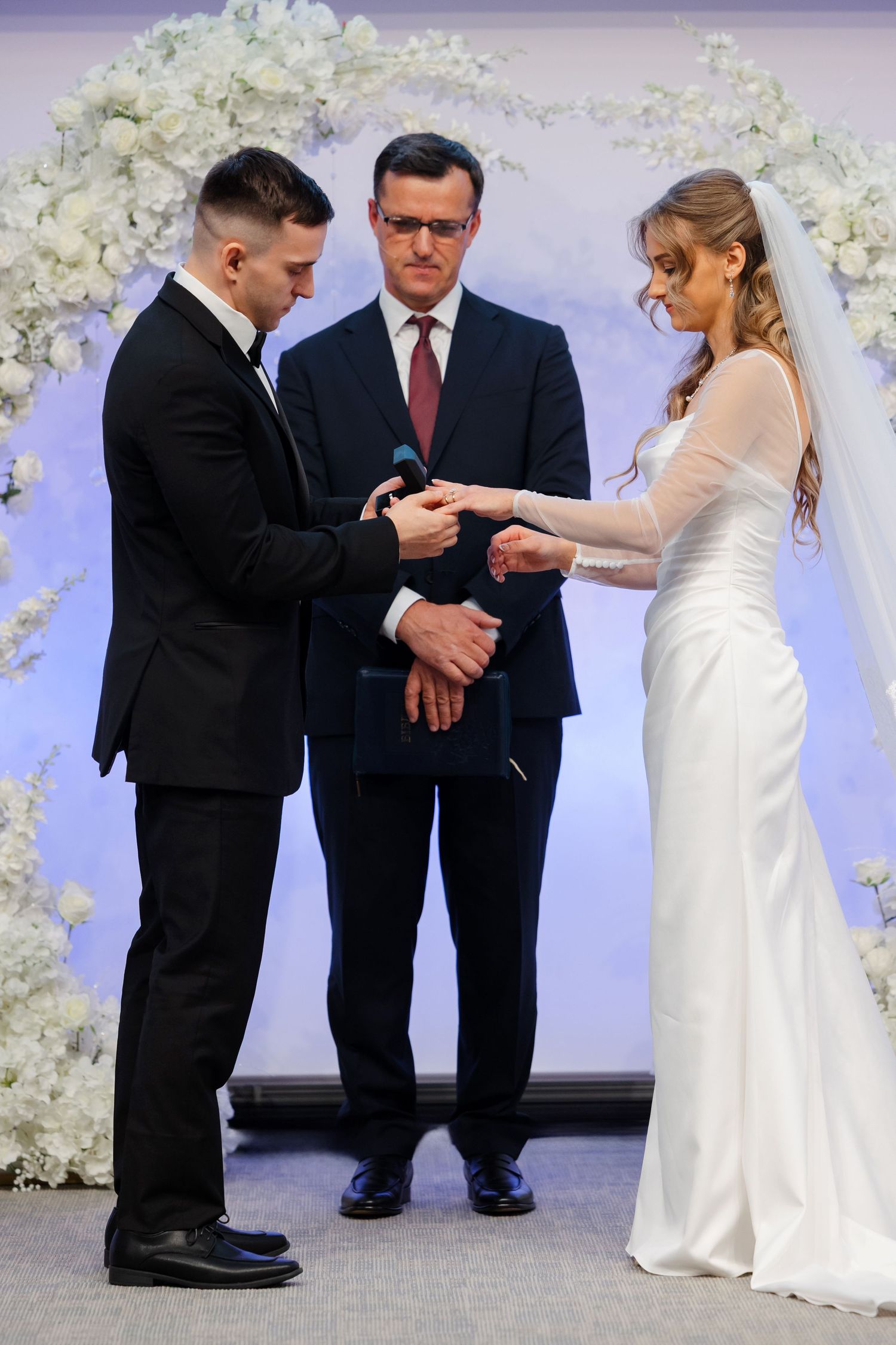 Bride and groom exchange rings during Ohio wedding ceremony photographed by Tom Forrest from Hudson, Ohio.
