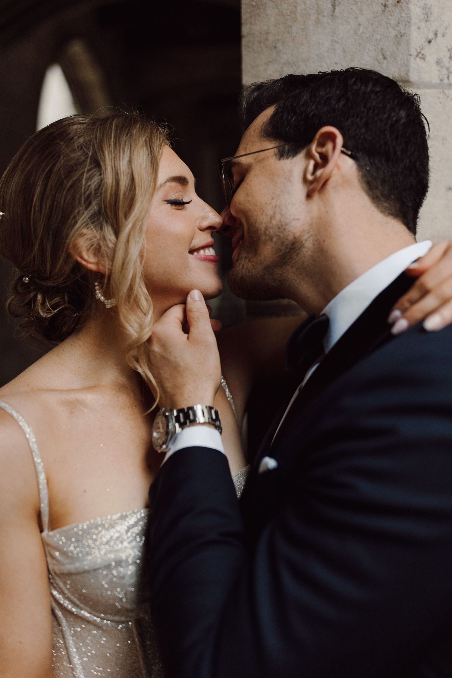 Romantic close-up of a couple sharing an intimate moment in a dimly lit setting.