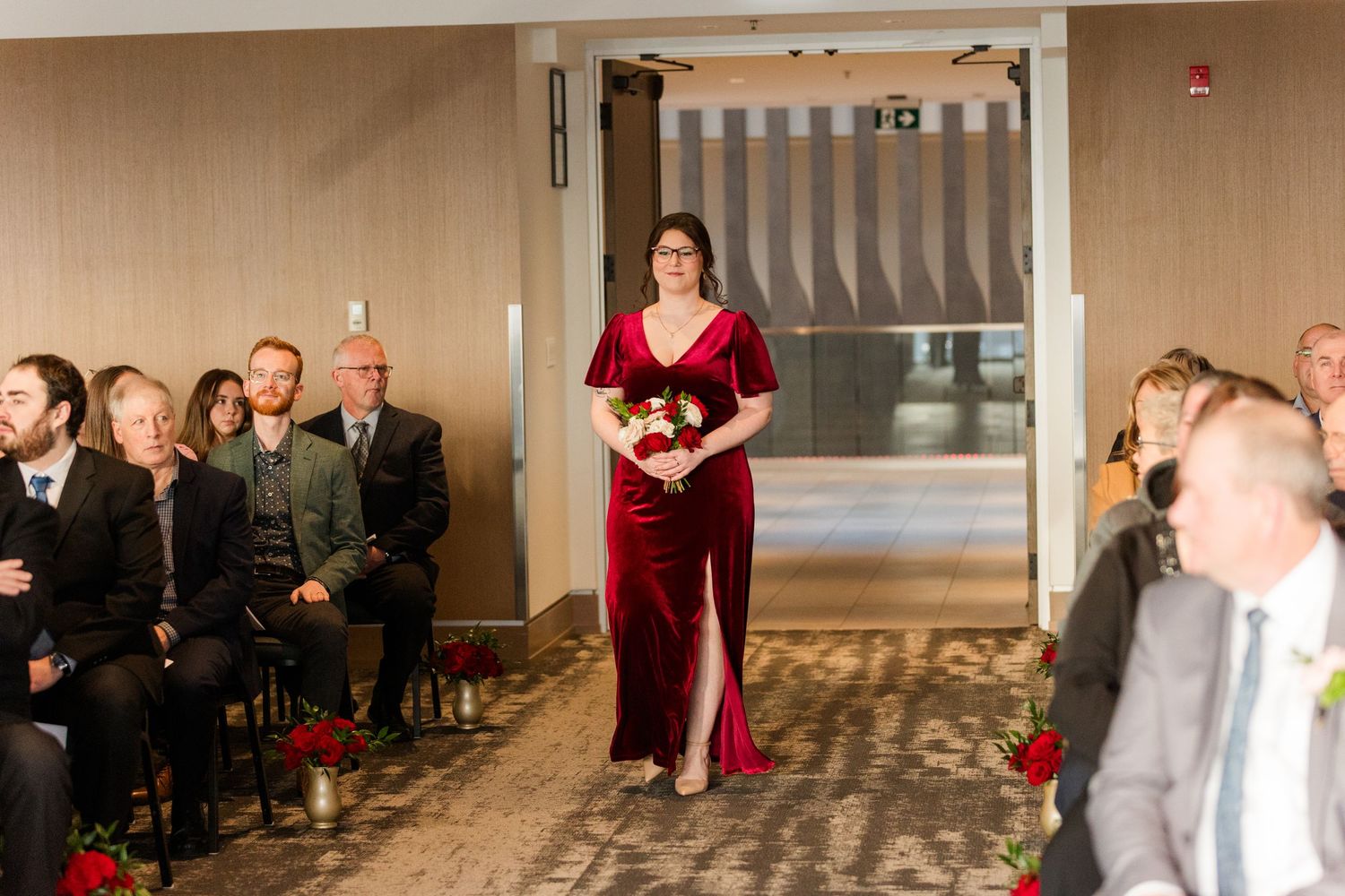 A wedding reception dance sequence showing guests and a couple in a red dress dancing in a banquet hall.