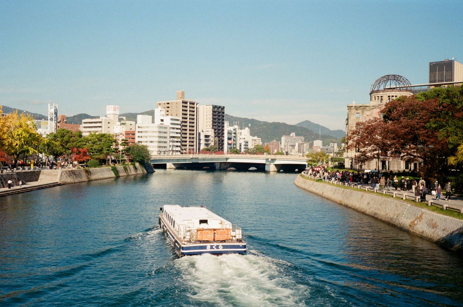 A series of waterfront city views showing boats, buildings, and urban landscapes along a harbor during daytime.