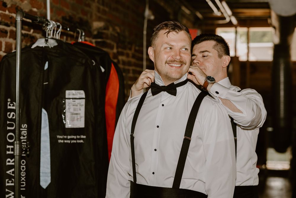 Groom putting on tie at Mill & Mine Knoxville, wedding photography by Allie Krauser Digitals