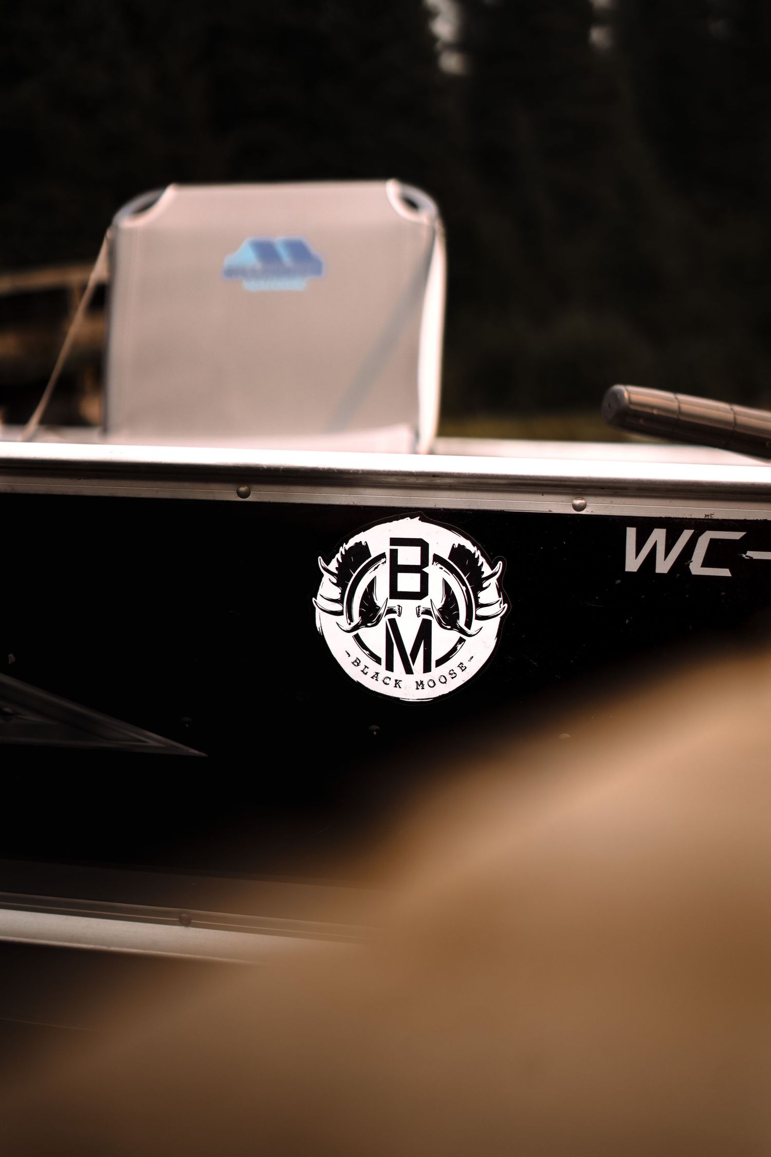Boat logos and branding details on dark background.