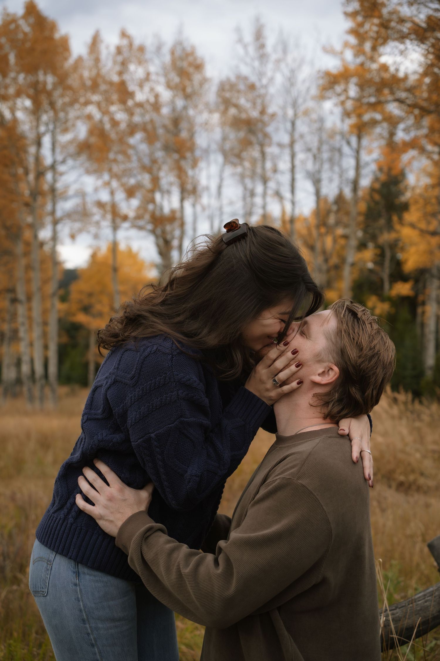 Intimate moment captured in golden field during sunset.