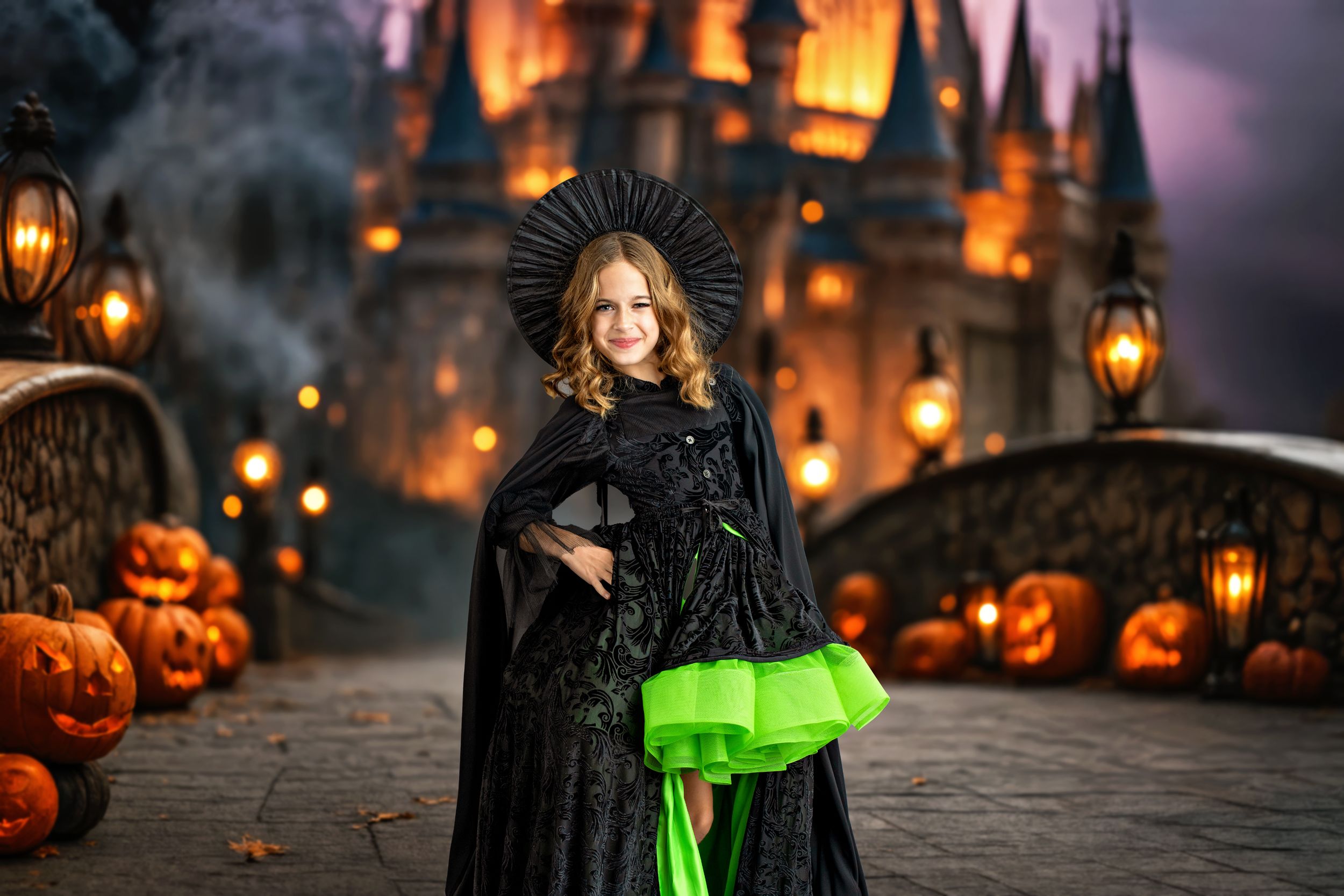 A girl standing in an Elphaba witch costume in front of a castle