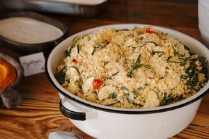 A step by step process of making chicken fried rice in a wok, showing ingredients being combined and cooked together.