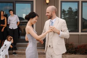 Wedding party enjoying candid moments and laughter during an outdoor celebration.
